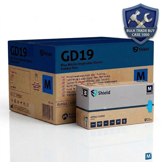 Shield GD19 blue nitrile powder-free disposable gloves hero shot featuring a large bulk case of 1000 gloves and a single dispenser box of 100, set against a clean white background with a "Bulk Trade Buy" shield icon